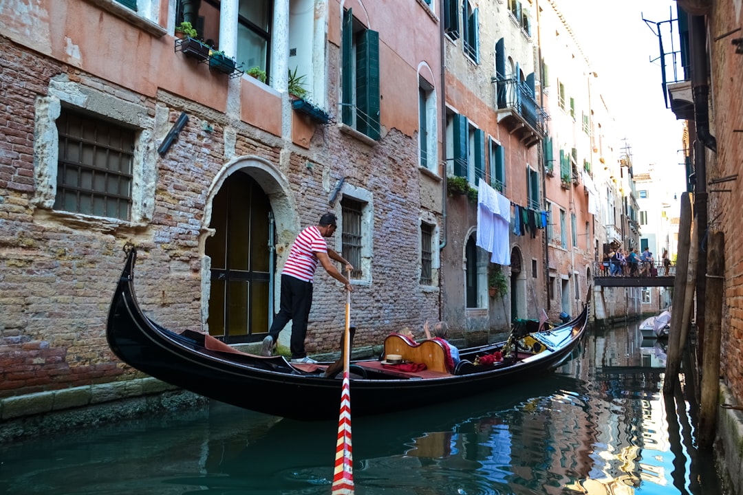 man in black boat on river during daytime