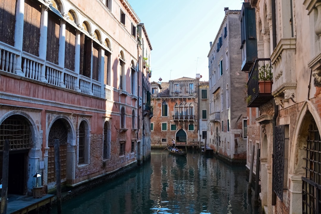 river between concrete buildings during daytime