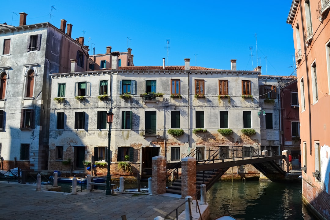 white and brown concrete building near body of water during daytime