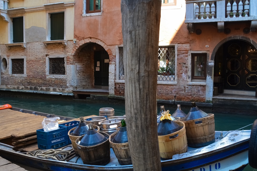 brown wooden post near blue and white boat on water during daytime