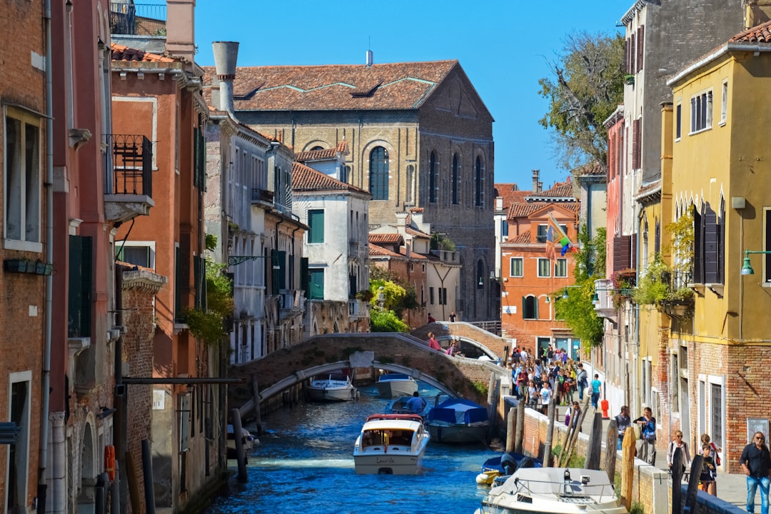 people walking on bridge near buildings during daytime