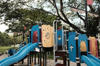 blue and brown metal playground swing
