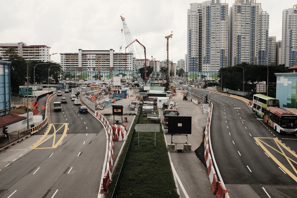 cars on road near city buildings during daytime