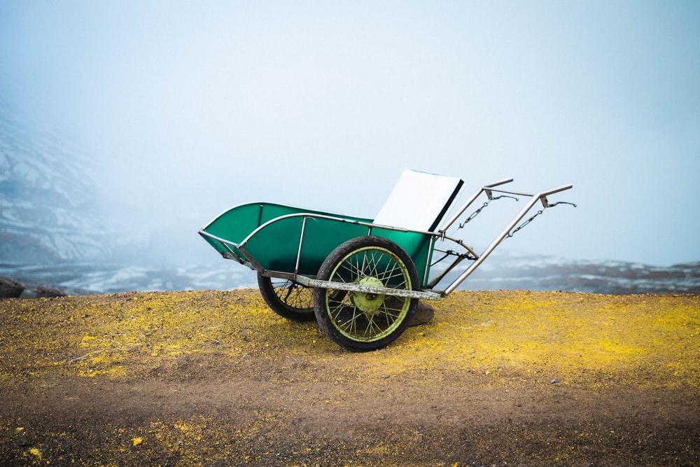 green and brown wheel barrow on green grass field during daytime