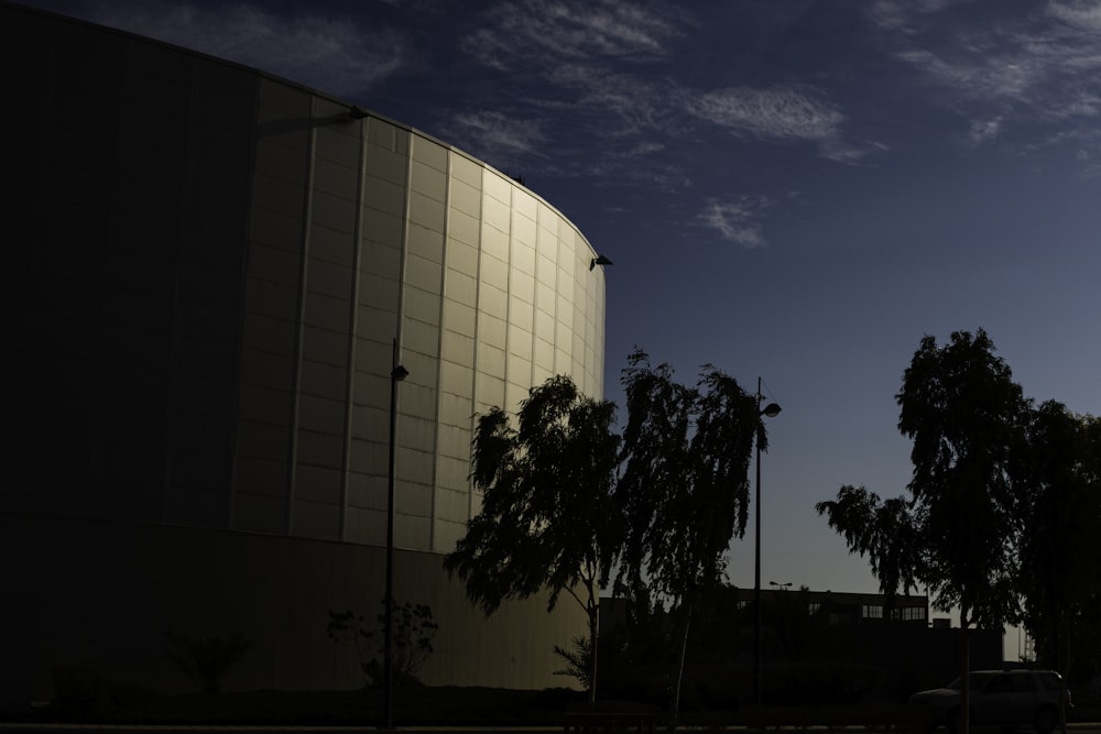 white concrete building near trees during daytime