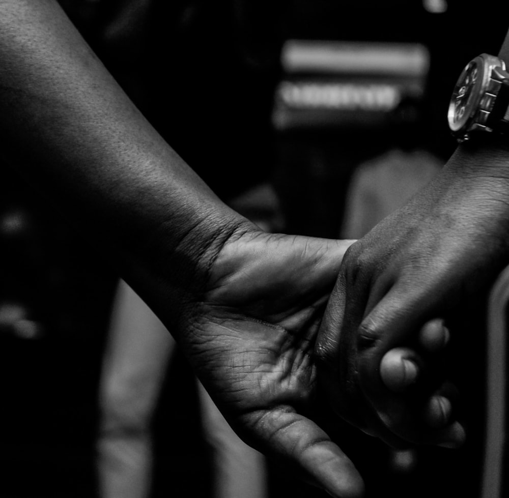 grayscale photo of person holding ring