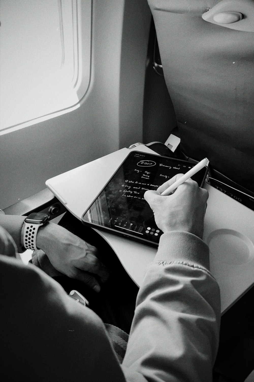 person in white long sleeve shirt holding white smartphone