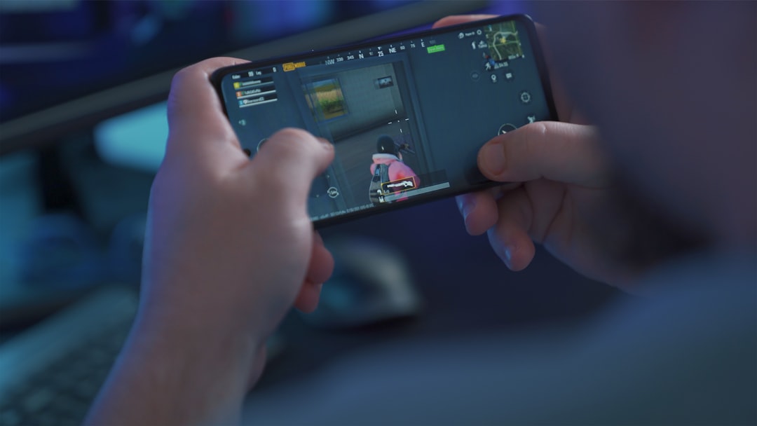 person holding black android smartphone, Playing a PUBG Mobile battle royale games