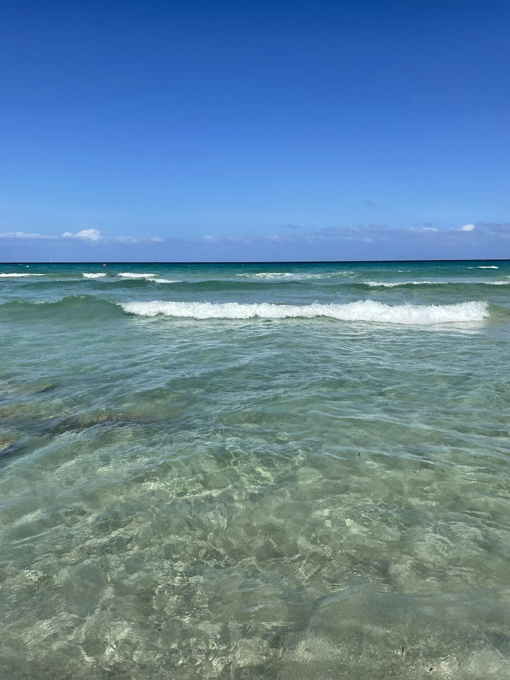 ocean waves crashing on shore during daytime