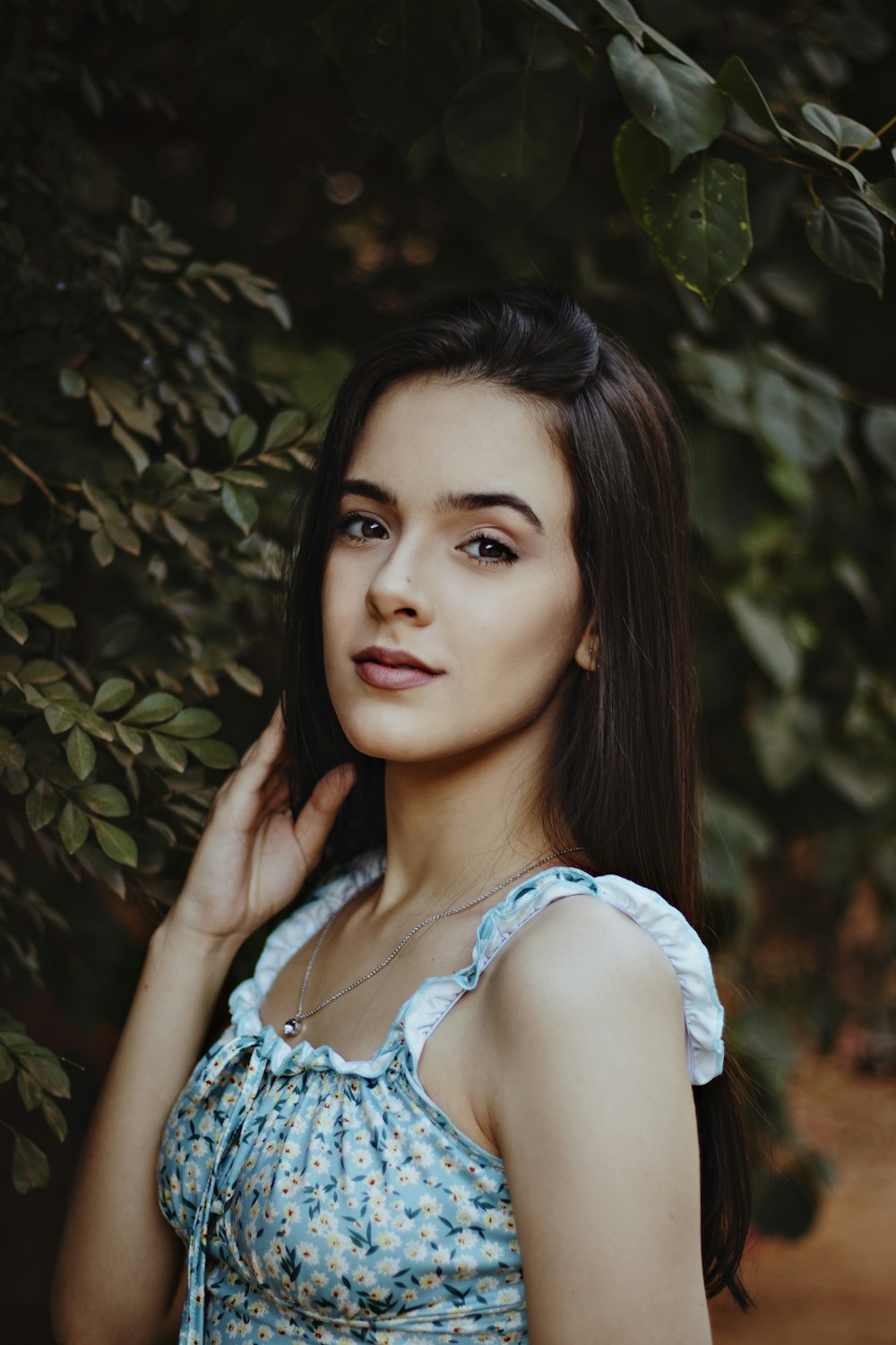 woman in white and blue floral tank top