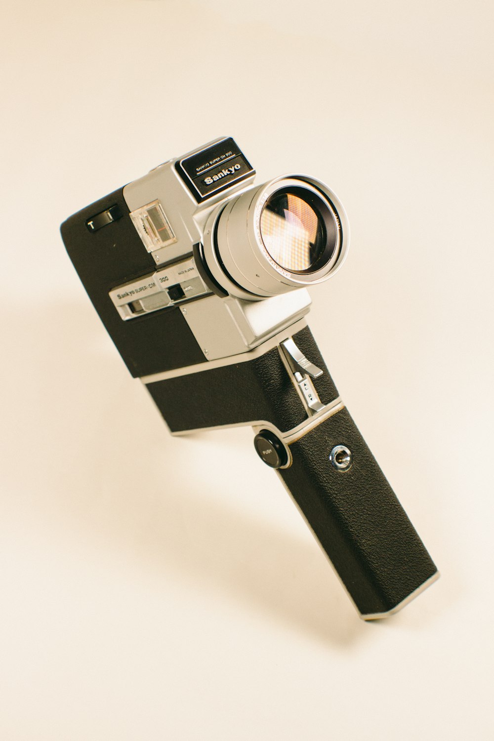 black and silver camera on white surface