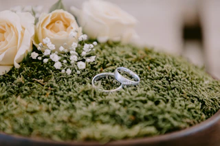 silver and gold rings on green textile