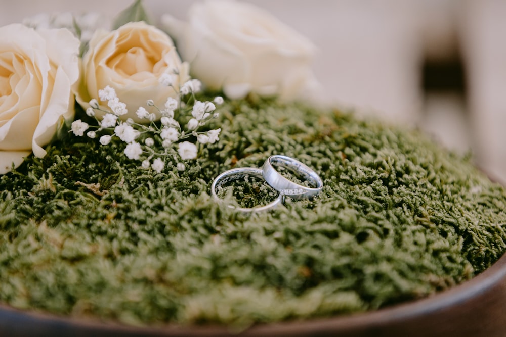 silver and gold rings on green textile