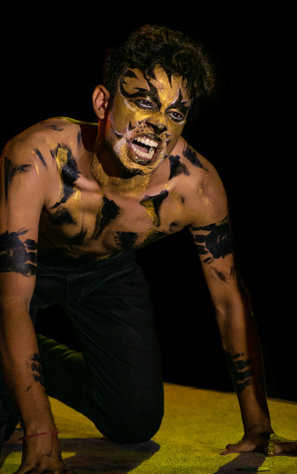 man with yellow and black face paint