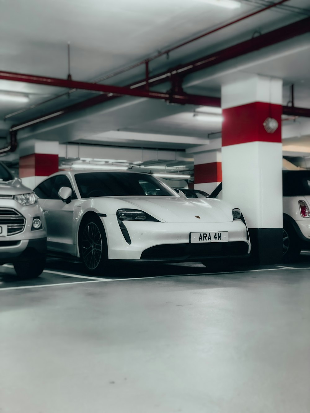 white porsche 911 parked in a room