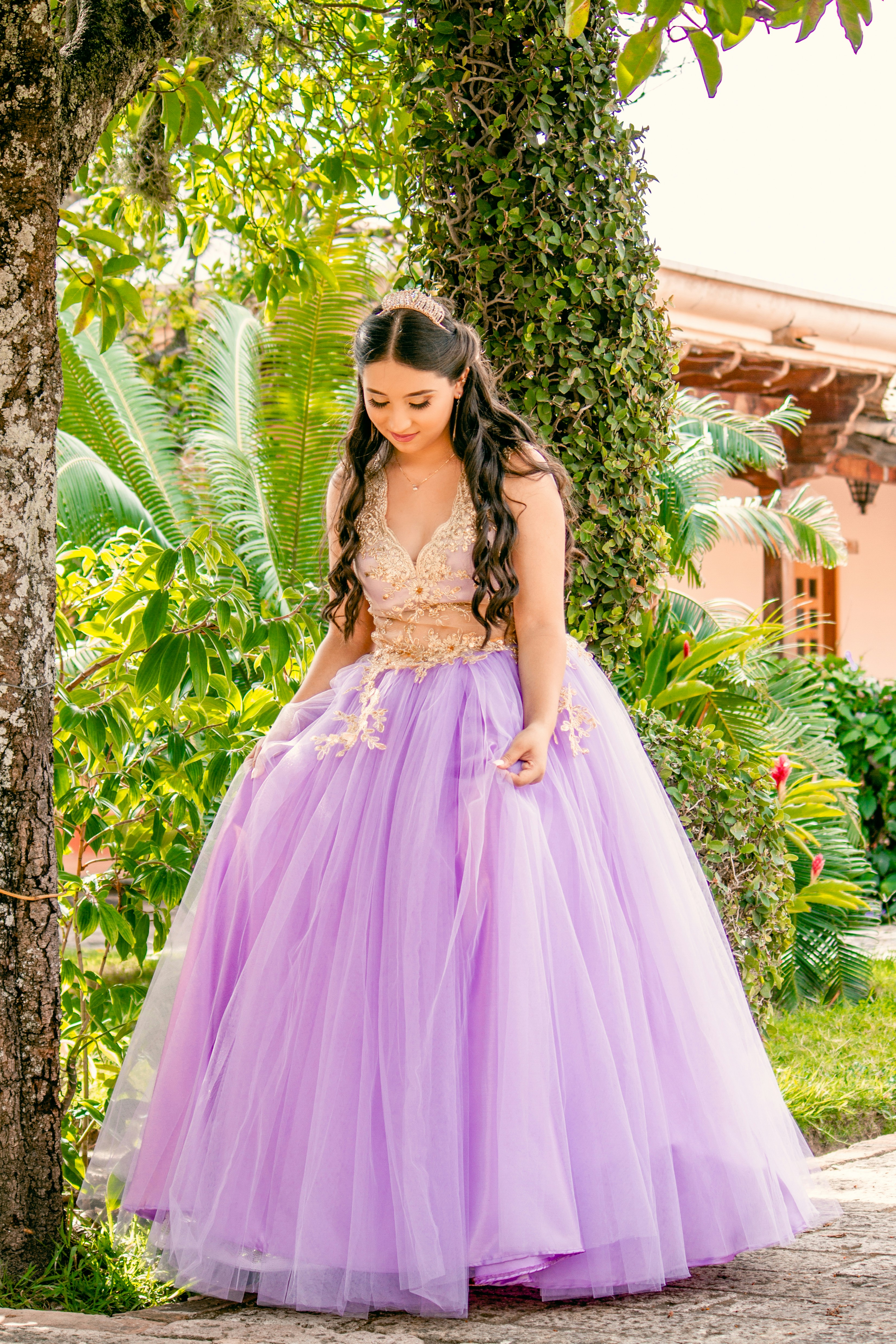 woman in pink dress standing near green plants during daytime