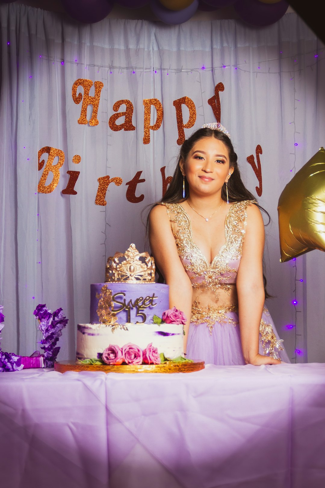 woman in yellow dress holding white and pink floral cake