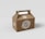 A brown cardboard box with a handle on top, featuring branding and the text 'GRUPOSEPAPEL'. The surface appears smooth with a seal-like logo and text in white.