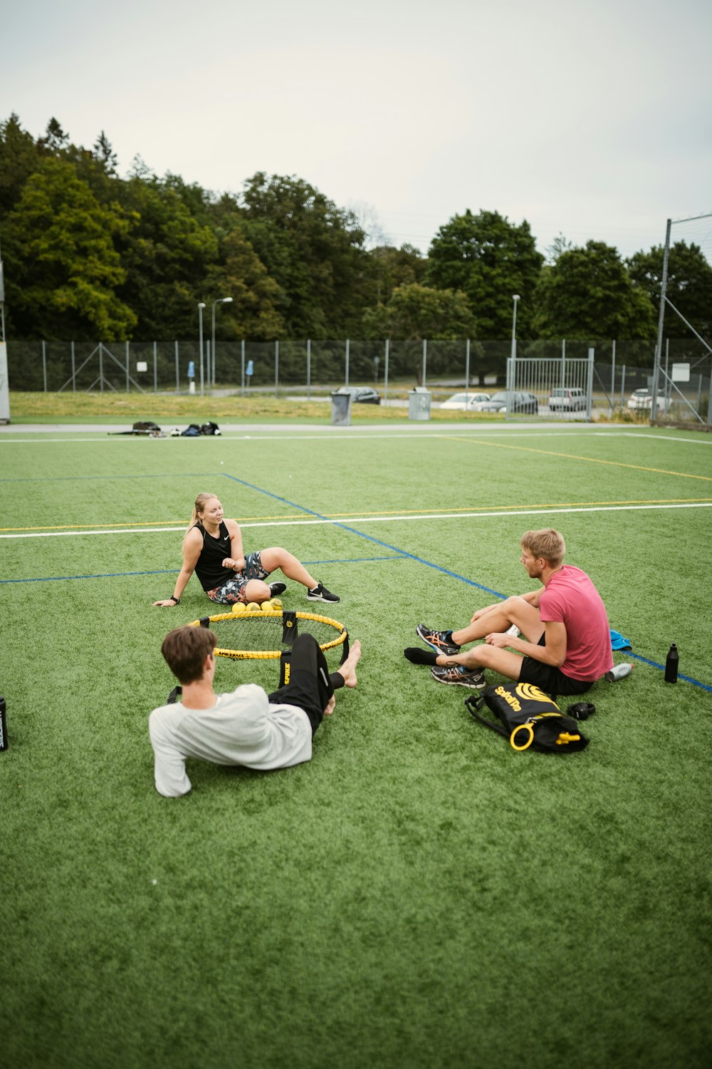 people playing soccer on green grass field during daytime