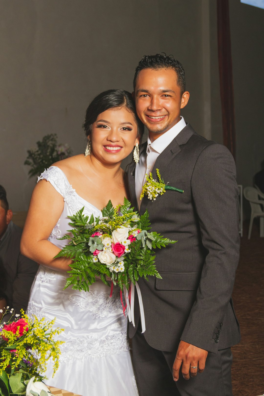 man in black suit jacket beside woman in white wedding dress