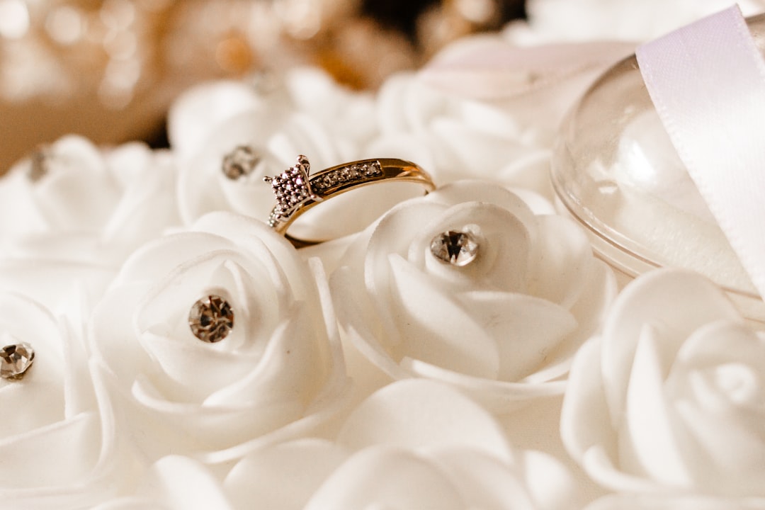 gold diamond ring on white flower