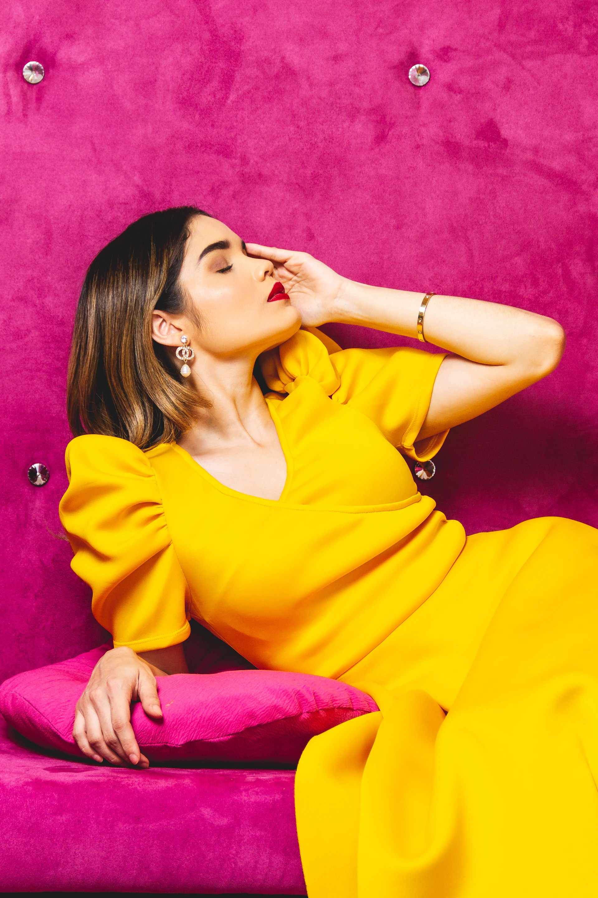 woman in yellow dress sitting on purple textile