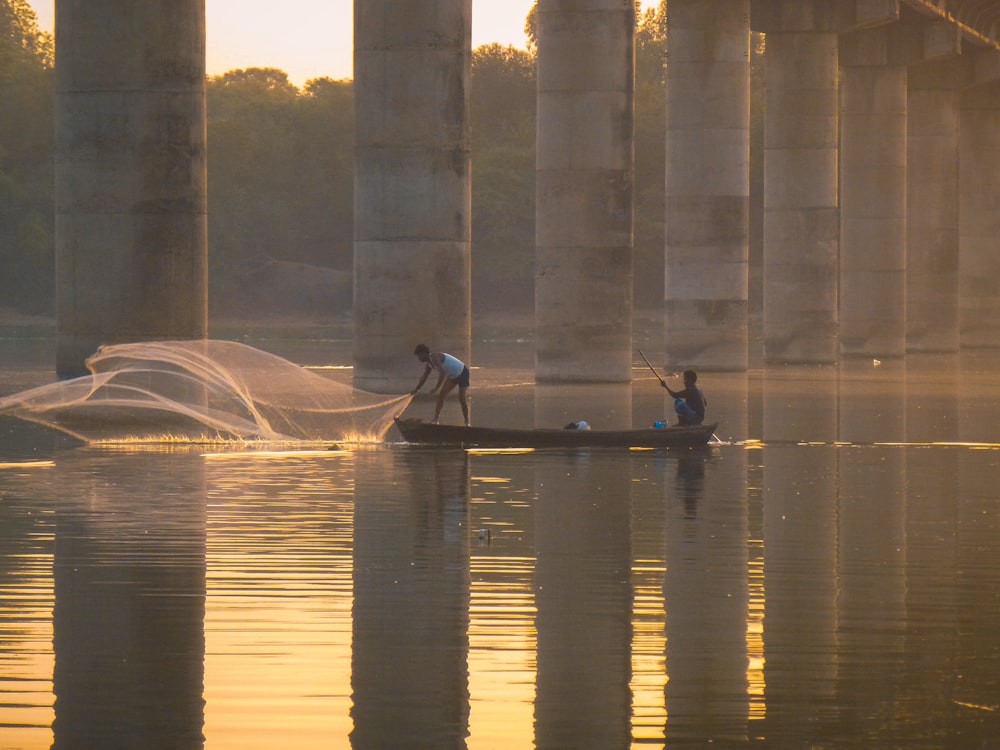 man riding on boat on river during daytime