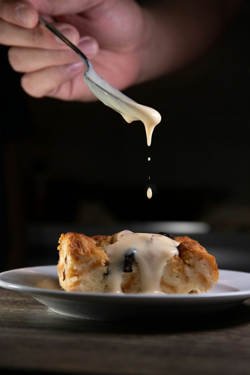 person holding stainless steel fork with white cream