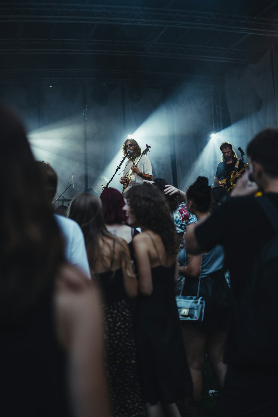 people standing on stage with lights