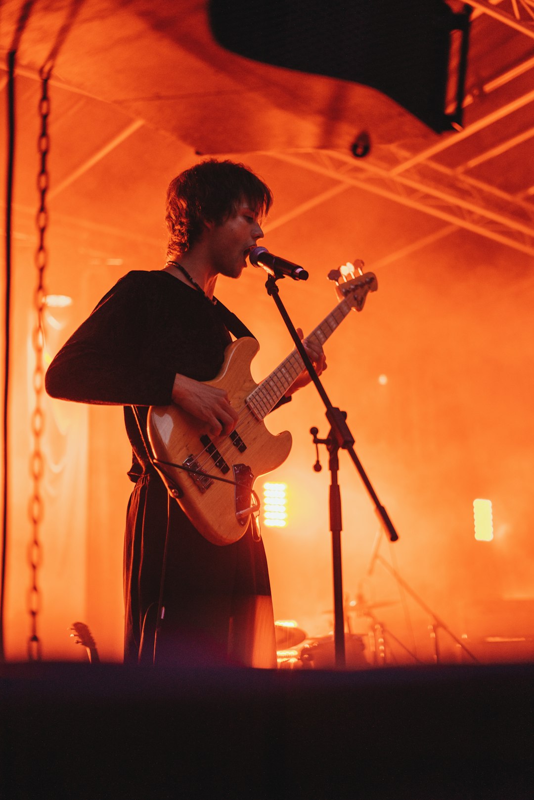 man in black shirt playing guitar