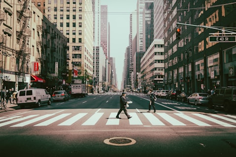 Pedestrian walking on crosswalk near traffic