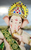 Lord Ganapati in gold and green crown