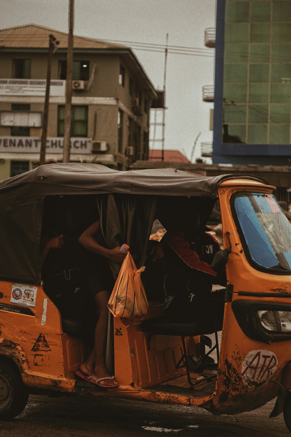 orangefarbenes Auto mit schwarzem Regenschirm oben drauf