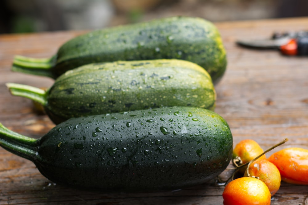 green cucumber on brown wooden table