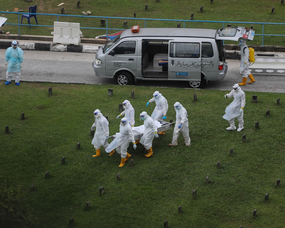 people in white karate gi on green grass field during daytime