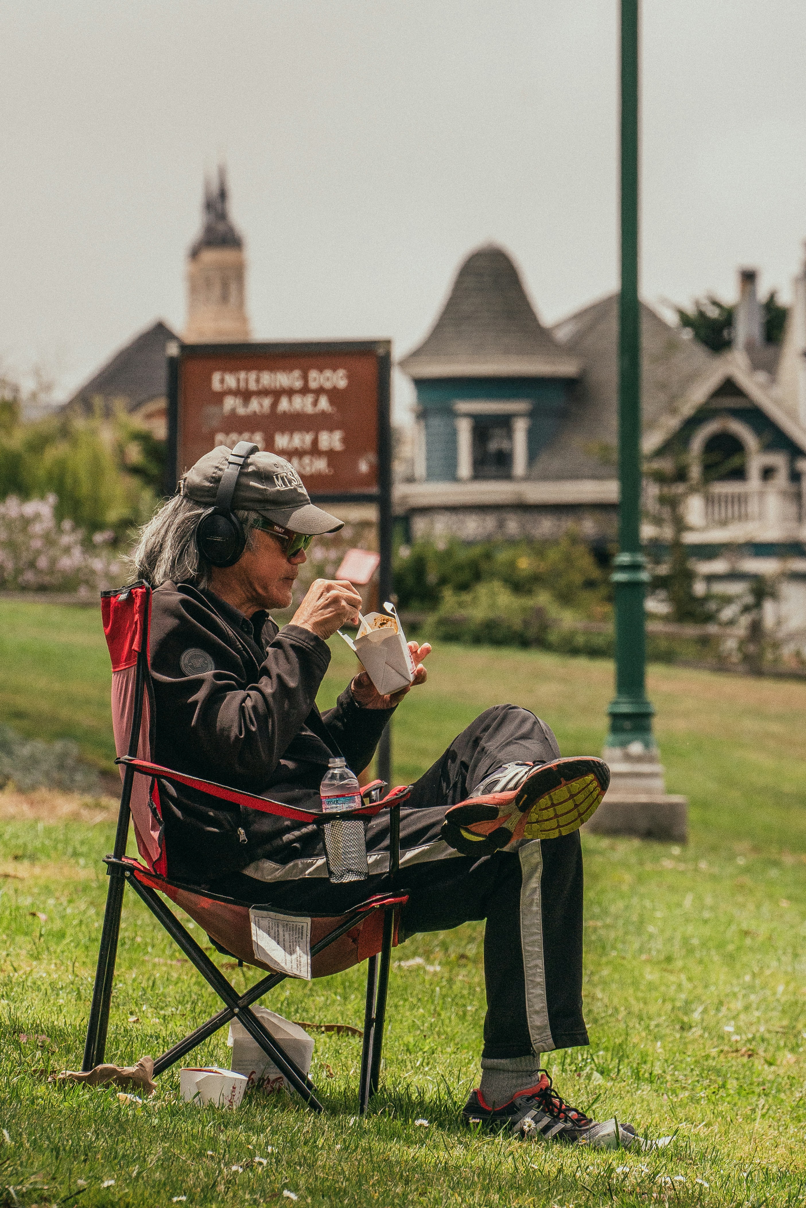 man in black jacket sitting on black and red stroller