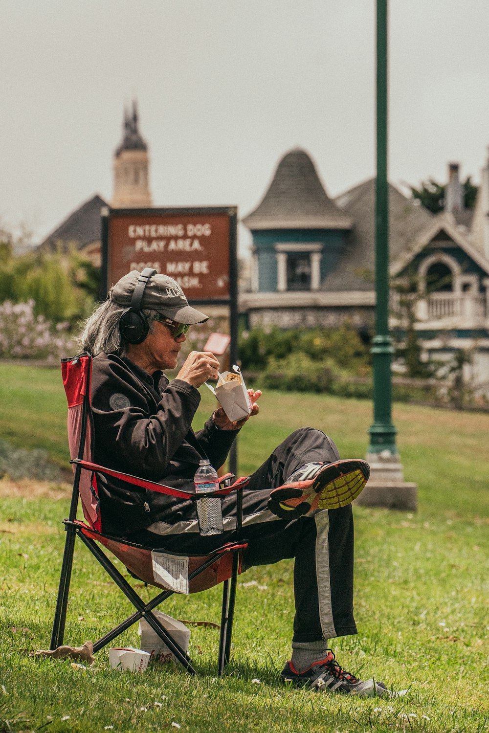 man in black jacket sitting on black and red stroller