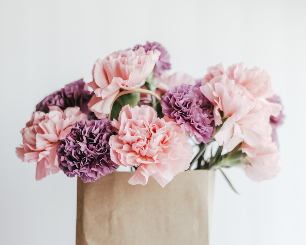 pink roses in brown vase