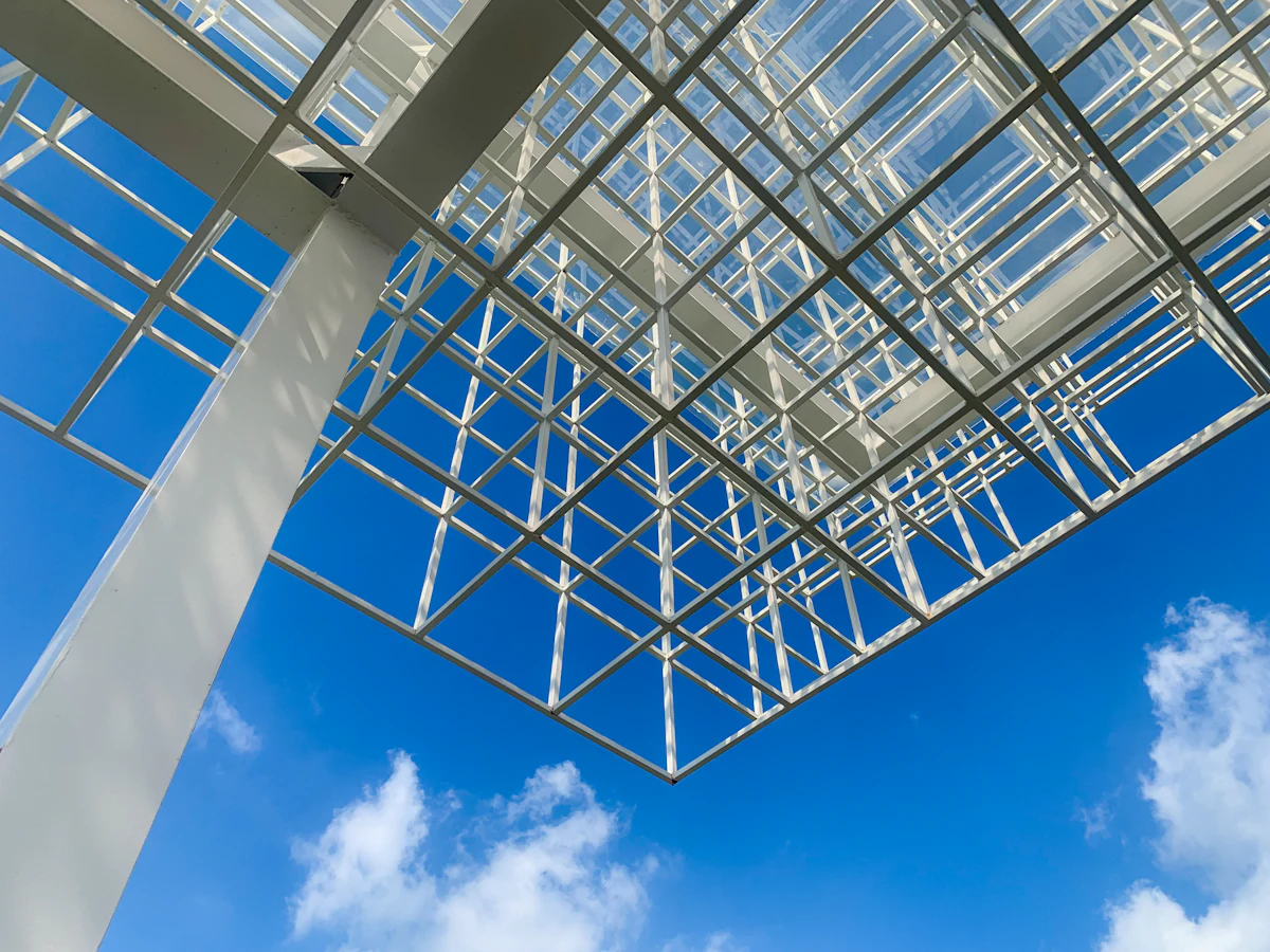 White metal structural canopy against blue sky