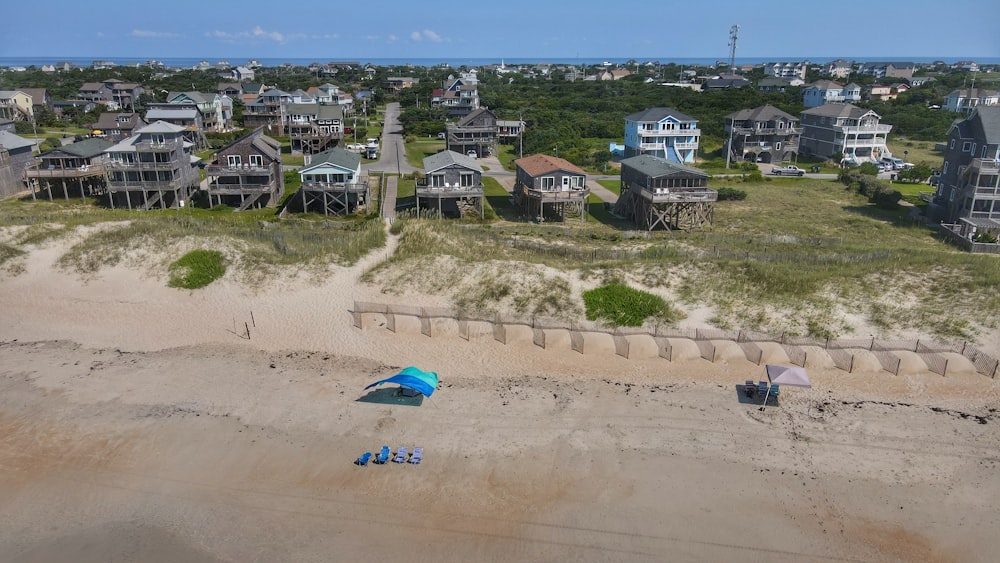 blue car on brown sand during daytime