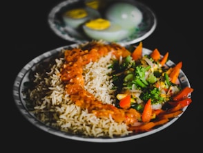 rice with sliced lemon and green vegetable on plate