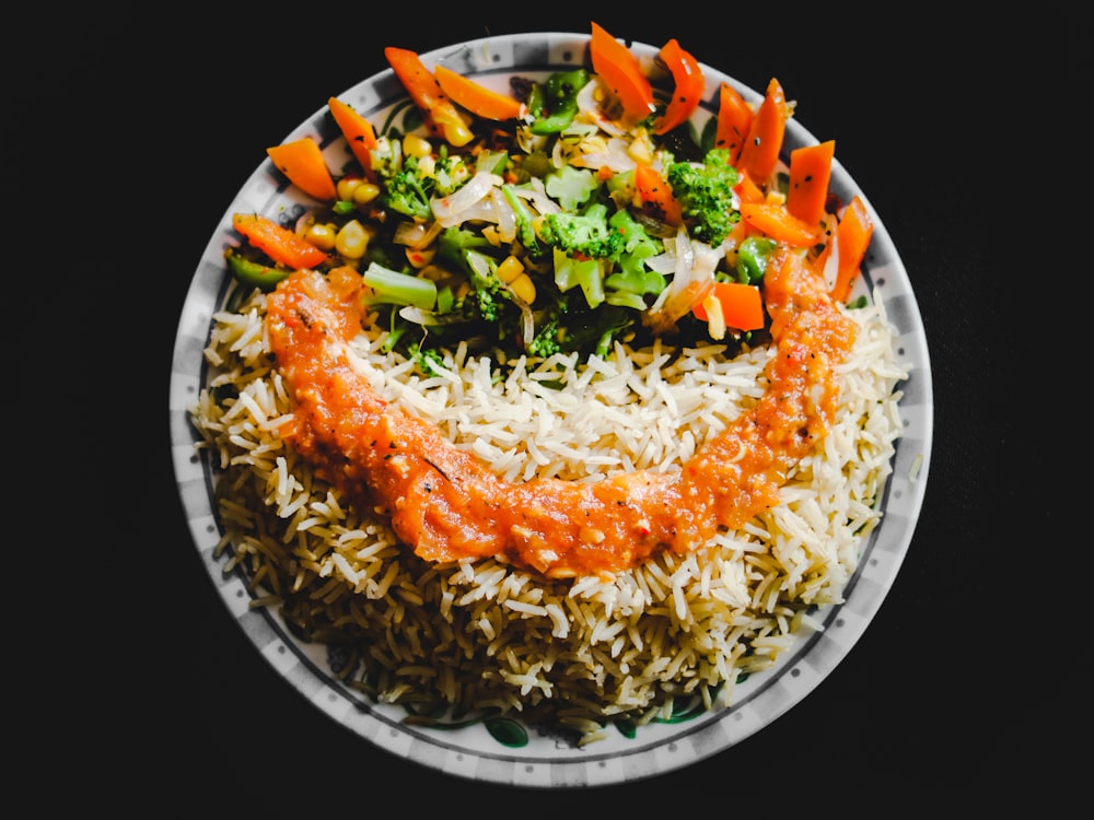 cooked rice with vegetables on white ceramic plate