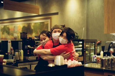 A warm, candid photo of Valen Homecare founders in scrubs, smiling after a long shift during the pandemic.