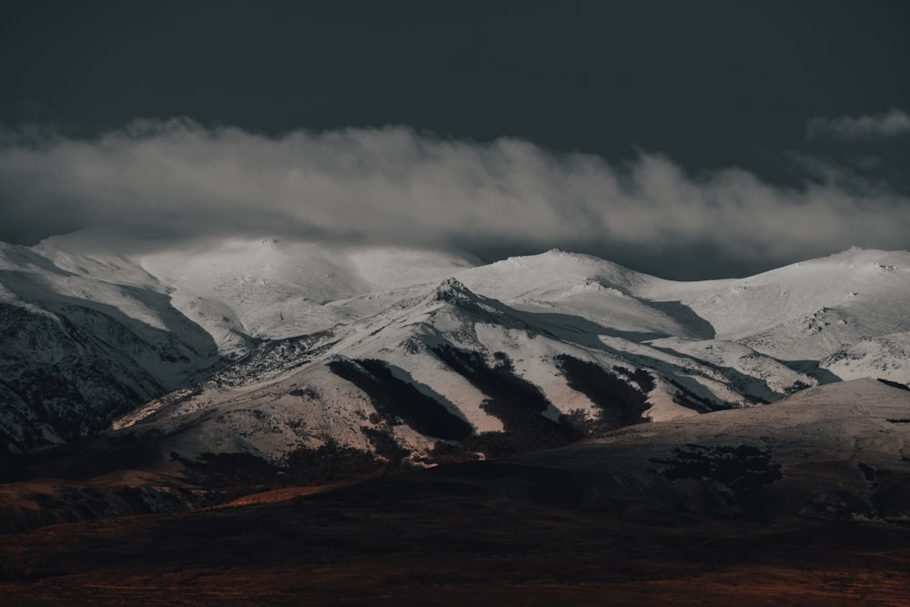 snow covered mountain under cloudy sky during daytime