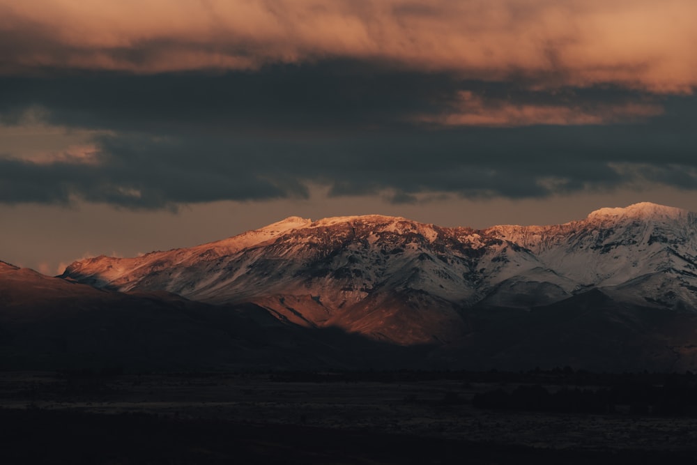 brown mountains under cloudy sky during daytime