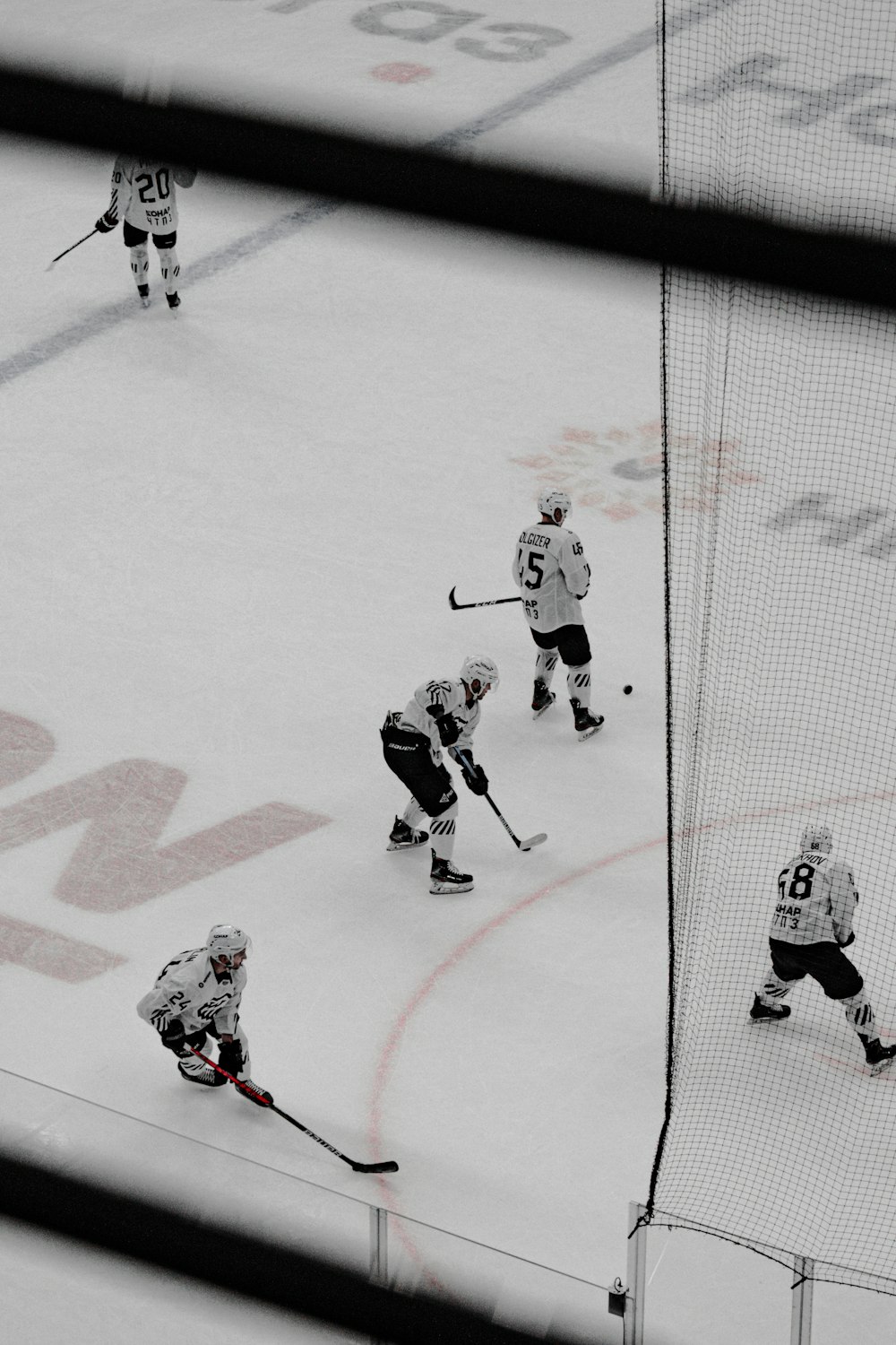 2 men playing hockey on ice field