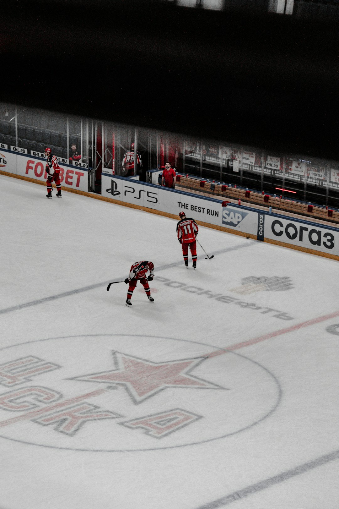 man in red jersey shirt playing hockey