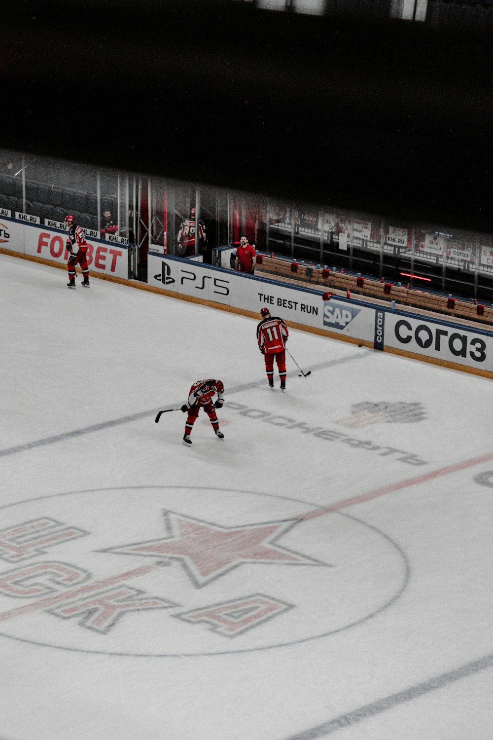 man in red jersey shirt playing hockey