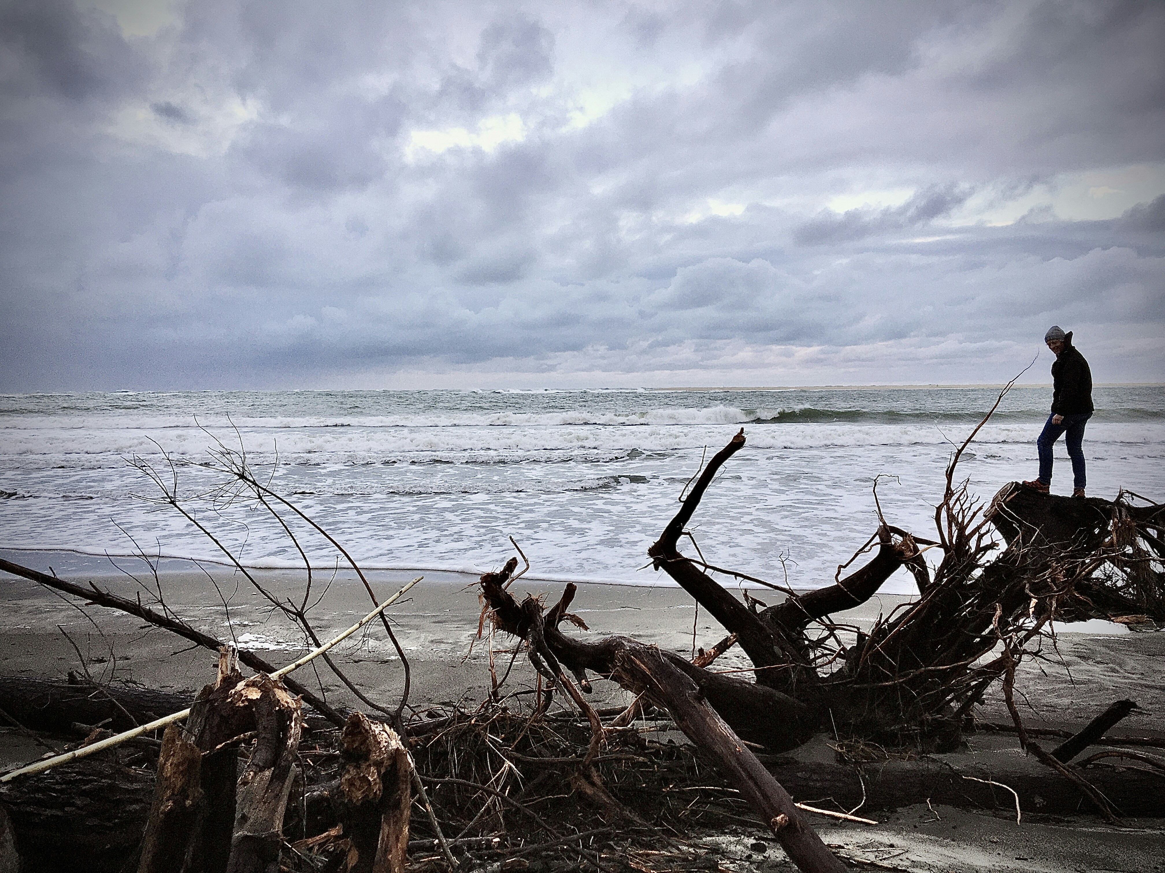 Viking warrior standing on a ship deck with stormy seas and dramatic clouds behind