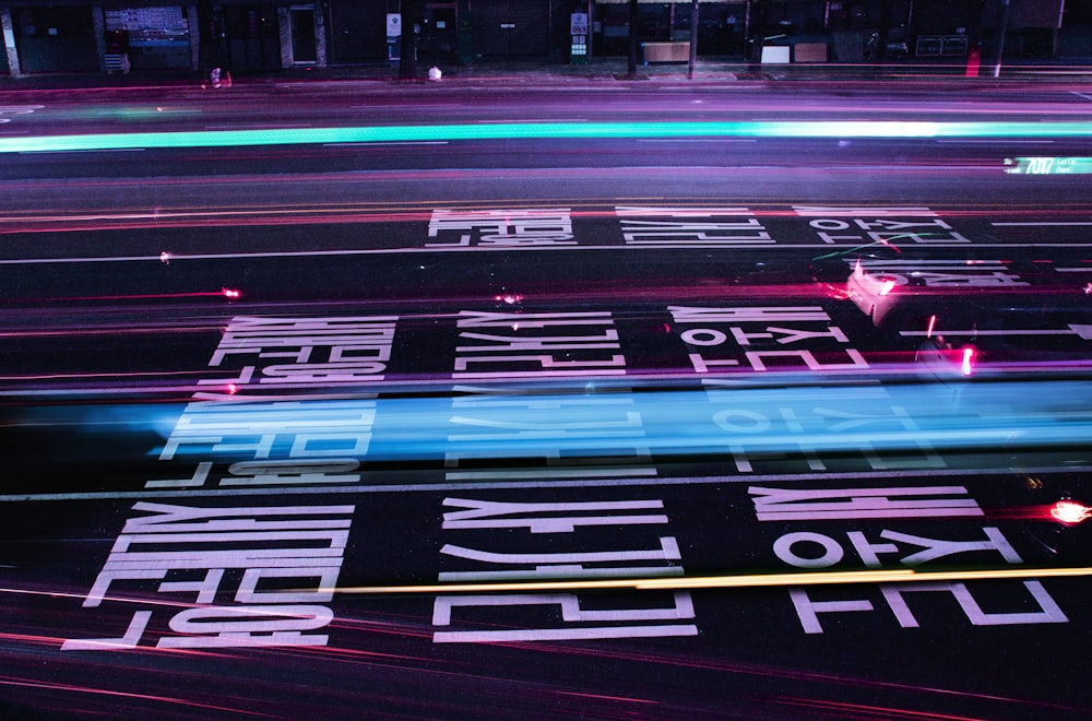 a city street at night with neon lights